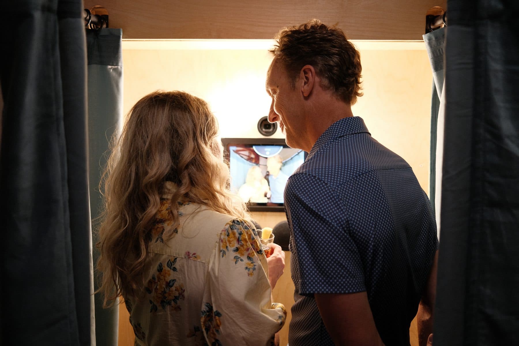 Two wedding guests recording a message inside the booth