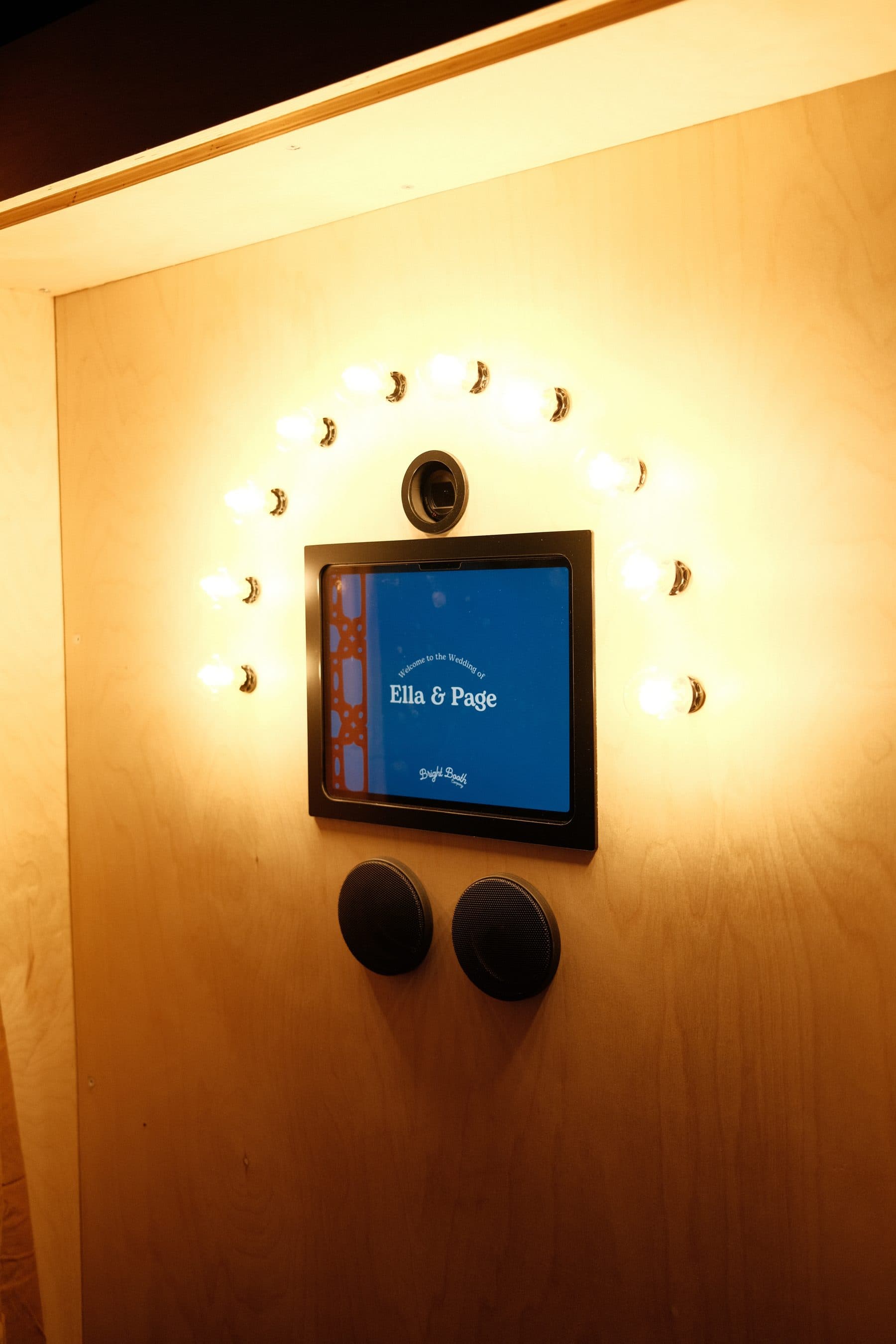 The booth's welcome screen ringed by warm light